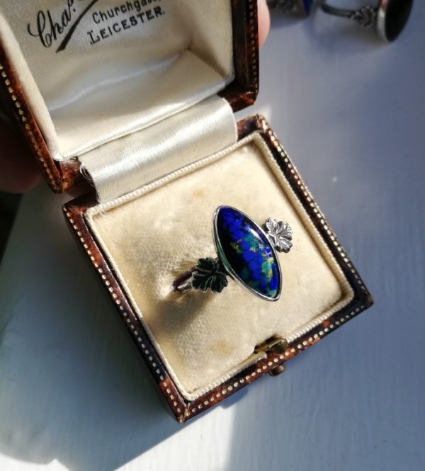Bernard Instone blue, metallic green, gold enamel plaque Arts and Crafts ring with double band signed, c1930