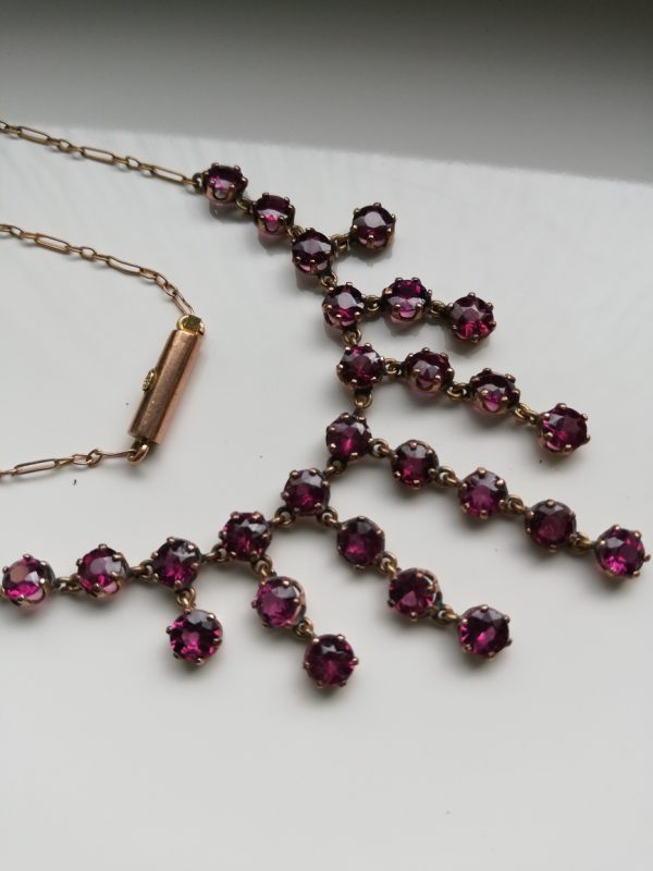 Edwardian c1900 9ct gold and 27 dark pink, glittering pink tourmalines fringe necklace, barrel clasp
