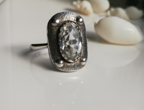 Attractive Arts and Crafts c1920-1930 hammered silver, faux rivets, silver and rock crystal ring