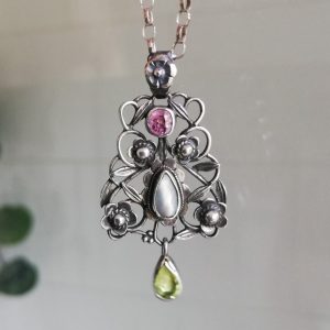 Arthur and Georgie Gaskin Arts and Crafts silver pendant c1900 in silver with pink tourmaline and peridot
