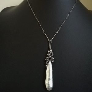 Long drop c1900 Arts and Crafts hand-wrought leaves and knots pendant necklace in silver and mother-of-pearl