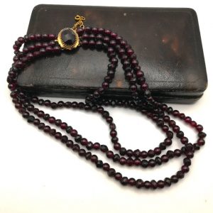 Victorian three strand garnets necklace with gold gem-set clasp and safety chain c1890