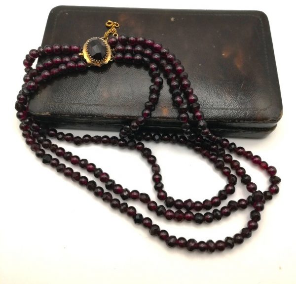 Victorian three strand garnets necklace with gold gem-set clasp and safety chain c1890