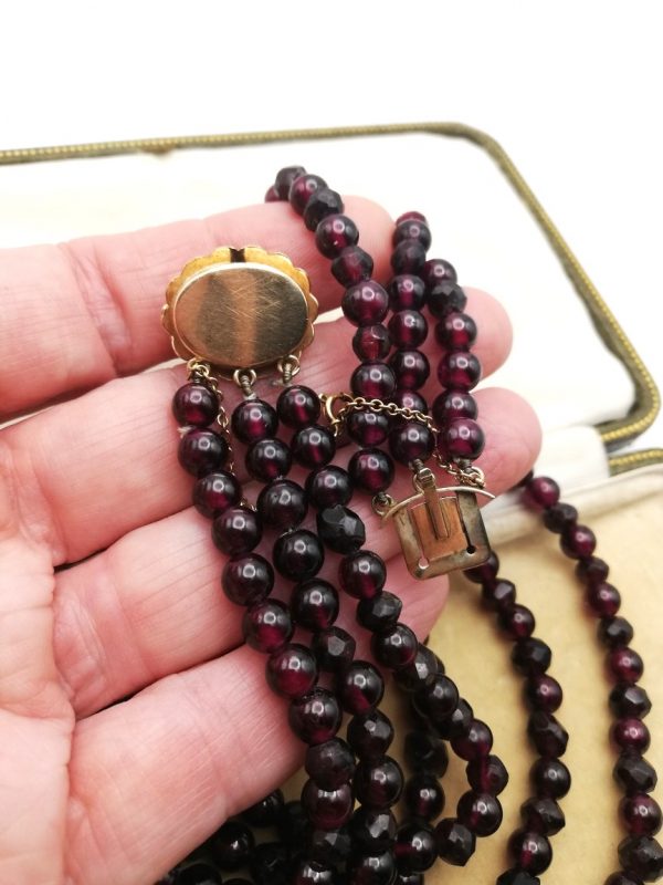 Victorian three strand garnets necklace with gold gem-set clasp and safety chain c1890