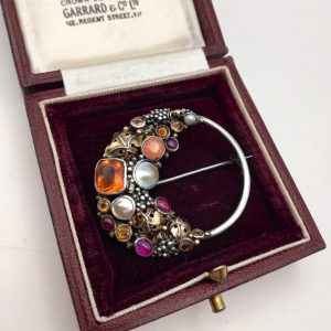 Fine Dorrie Nossiter Arts and Crafts brooch in silver with gold, fire opal and rubies c1930