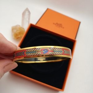 Boxed Hermès vintage gold plated and enamel bangle with links design in gold blue and red