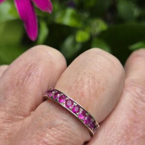 Art Deco 18ct white gold and 25 pink rubies eternity band- chased edges